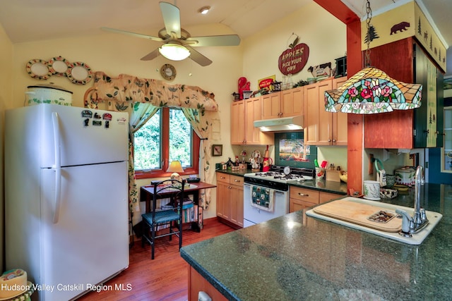 kitchen with wood-type flooring, white appliances, vaulted ceiling, and light brown cabinetry