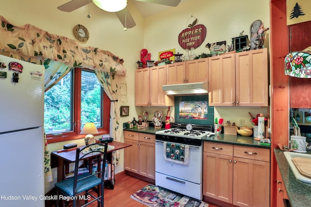 kitchen featuring hardwood / wood-style floors, light brown cabinets, white appliances, ceiling fan, and decorative backsplash