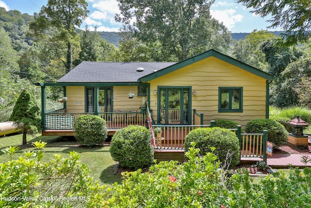 rear view of property with a deck with mountain view