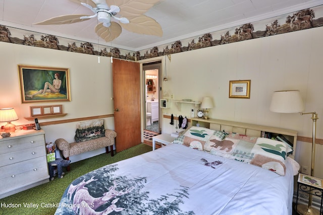 carpeted bedroom with ceiling fan and ornamental molding