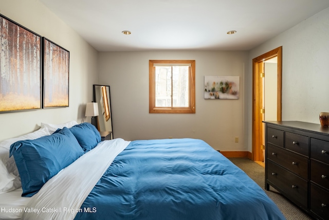 bedroom with carpet and baseboards