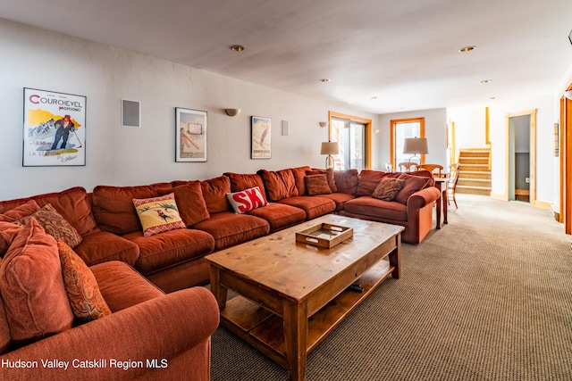 carpeted living room featuring stairway and recessed lighting