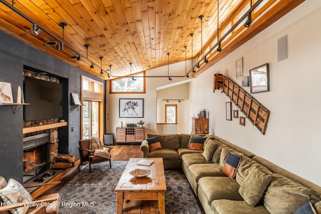 living area with a large fireplace, wood ceiling, vaulted ceiling, dark wood-style floors, and track lighting