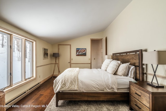 bedroom featuring lofted ceiling, a baseboard heating unit, multiple windows, and dark wood-style floors