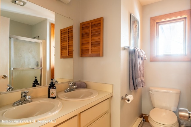 bathroom featuring toilet, double vanity, an enclosed shower, and a sink