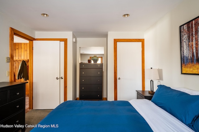 bedroom featuring a closet and dark carpet