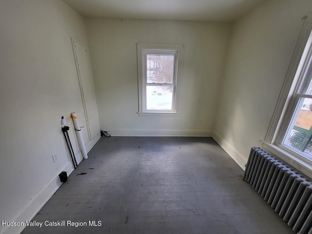 unfurnished room featuring radiator heating unit