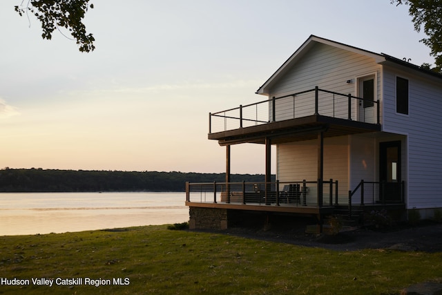 exterior space featuring a yard and a water view