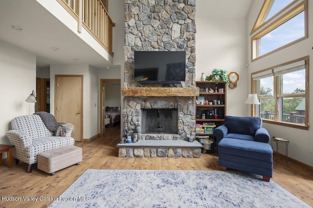 16 Wang Dr, Copake, NY 12516 - living room with a stone fireplace, a high ceiling, and wood finished floors