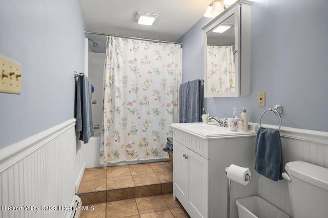 16 Wang Dr, Copake, NY 12516 - bathroom featuring vanity, wainscoting, a baseboard radiator, shower / tub combo, and tile patterned flooring