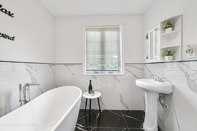 bathroom with tile walls, plenty of natural light, and marble finish floor