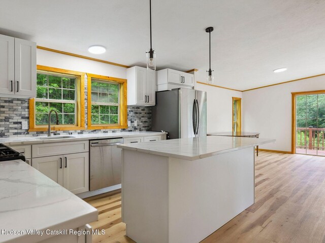 719 Allen Teator Rd, Durham, NY 12469 - kitchen with stainless steel appliances, light stone countertops, light wood-type flooring, tasteful backsplash, and crown molding