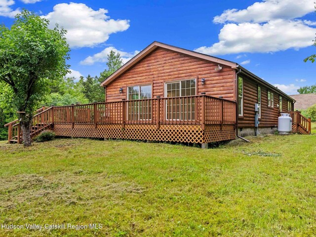 719 Allen Teator Rd, Durham, NY 12469 - back of house with a wooden deck, faux log siding, and a yard