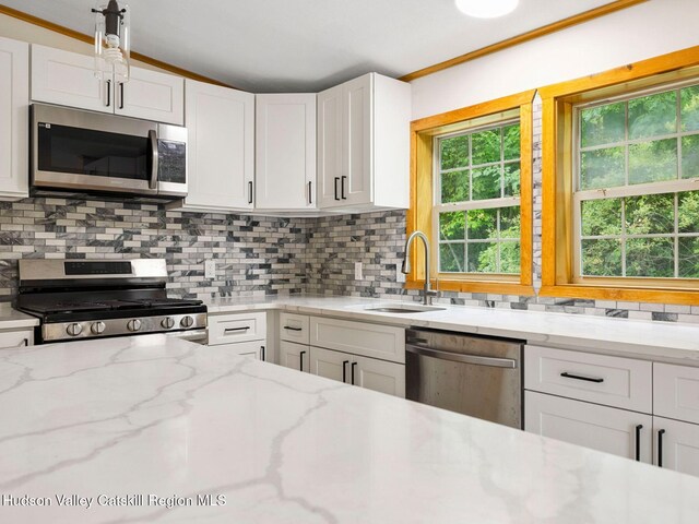 719 Allen Teator Rd, Durham, NY 12469 - kitchen with stainless steel appliances, white cabinetry, backsplash, and light stone countertops