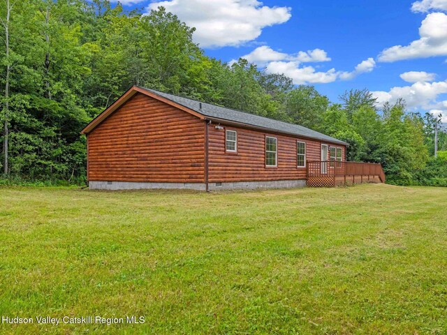719 Allen Teator Rd, Durham, NY 12469 - view of side of home with crawl space, a wooden deck, a yard, faux log siding, and a forest view