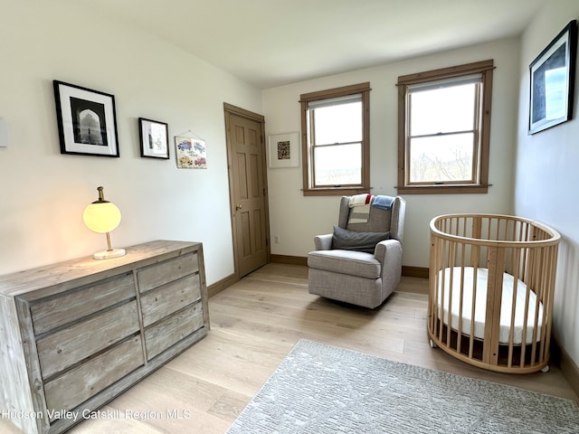 living area featuring light wood-style floors and baseboards