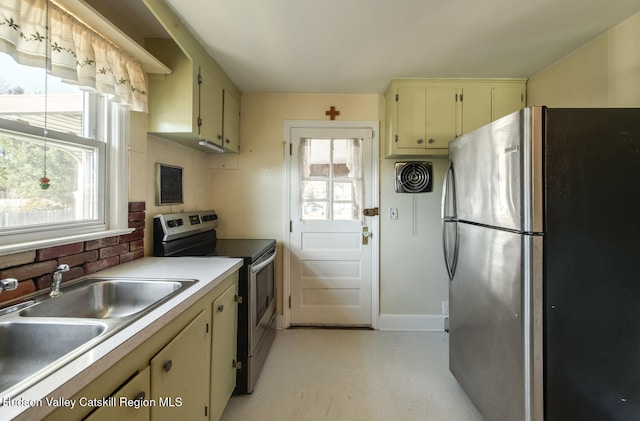 kitchen with cream cabinets, sink, and appliances with stainless steel finishes