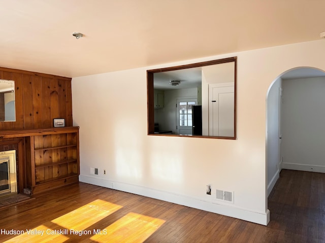 unfurnished living room featuring hardwood / wood-style flooring