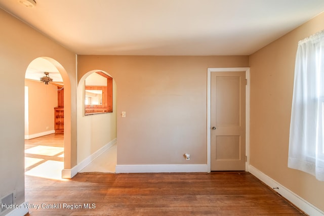 spare room with ceiling fan and hardwood / wood-style floors