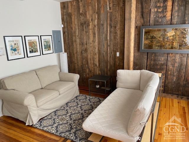 17-23 Linden St, Pittsfield, MA 01201 - living room featuring wood finished floors, wooden walls, and electric panel