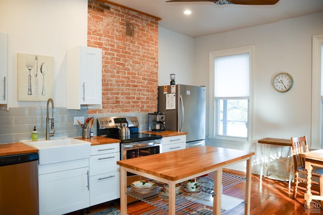 17-23 Linden St, Pittsfield, MA 01201 - kitchen with wooden counters, stainless steel appliances, white cabinetry, backsplash, and recessed lighting