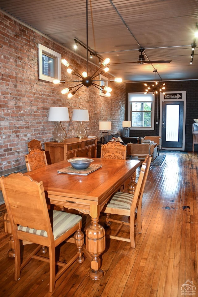 17-23 Linden St, Pittsfield, MA 01201 - dining room featuring brick wall, a chandelier, and hardwood / wood-style floors