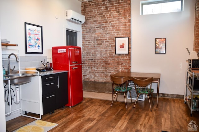 17-23 Linden St, Pittsfield, MA 01201 - kitchen featuring an AC wall unit, wood finished floors, and brick wall