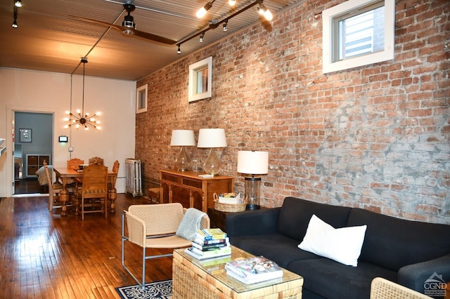 17-23 Linden St, Pittsfield, MA 01201 - living area with wood-type flooring, radiator heating unit, a chandelier, and brick wall