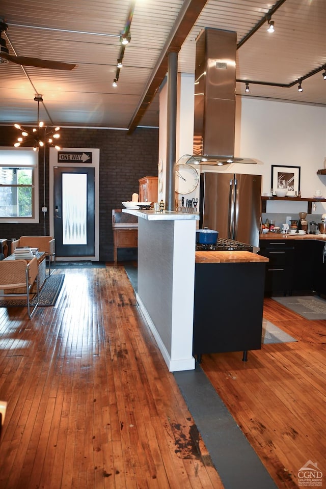 17-23 Linden St, Pittsfield, MA 01201 - kitchen with rail lighting, freestanding refrigerator, ventilation hood, hardwood / wood-style floors, and brick wall