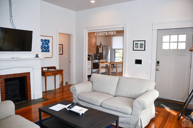 17-23 Linden St, Pittsfield, MA 01201 - living area with plenty of natural light, wood finished floors, and a brick fireplace