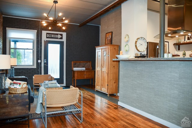 17-23 Linden St, Pittsfield, MA 01201 - dining area with wood finished floors, brick wall, a chandelier, and a high ceiling