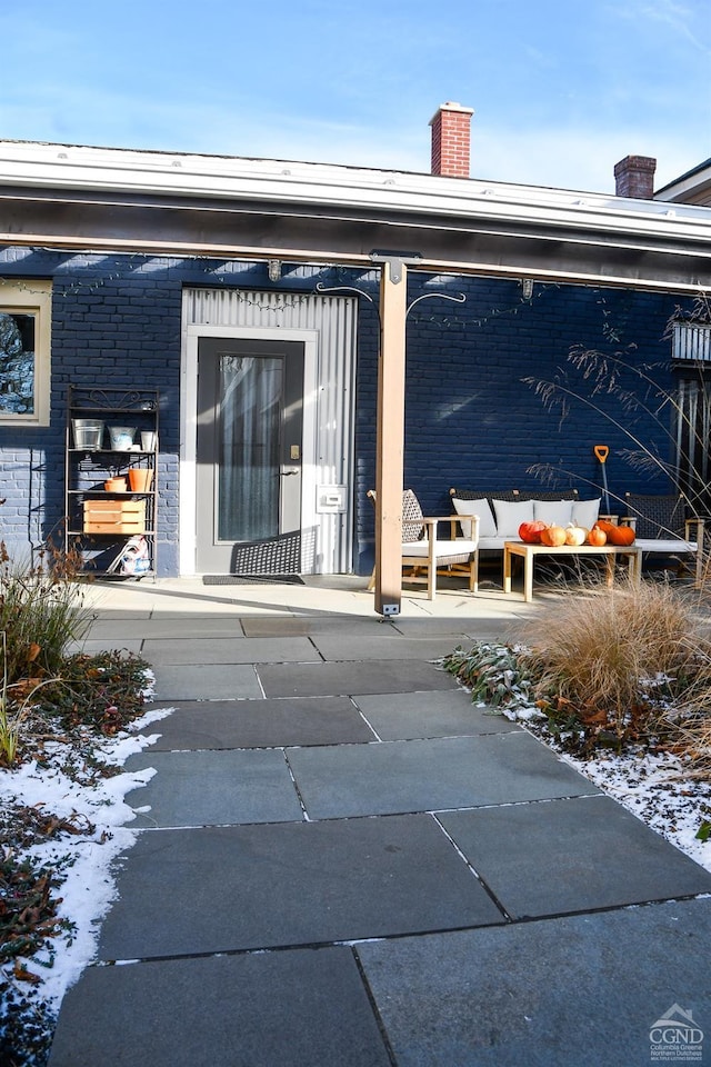 17-23 Linden St, Pittsfield, MA 01201 - doorway to property featuring an outdoor hangout area, brick siding, and a chimney