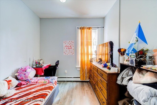 bedroom featuring light wood-type flooring and baseboard heating