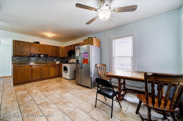kitchen featuring tasteful backsplash, dark countertops, brown cabinets, white gas range, and stainless steel refrigerator with ice dispenser