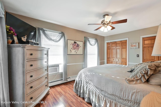 339-345 Jessup Rd, Florida, NY 10921 - bedroom featuring baseboard heating, wood finished floors, a ceiling fan, and a wall mounted AC