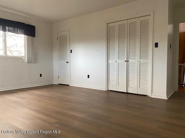 unfurnished bedroom featuring dark hardwood / wood-style flooring