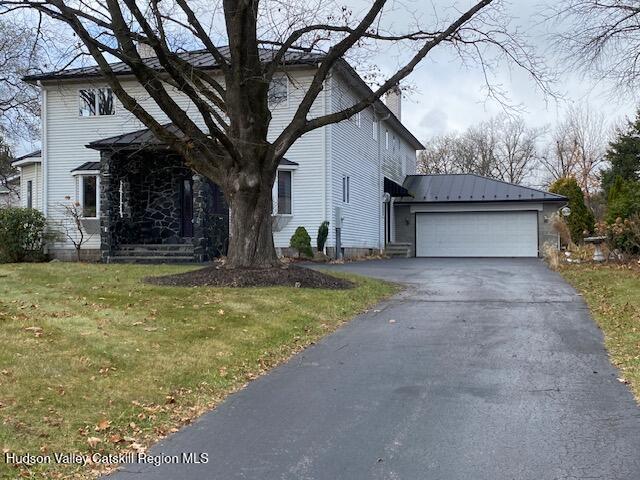 view of front of house with a front yard and a garage