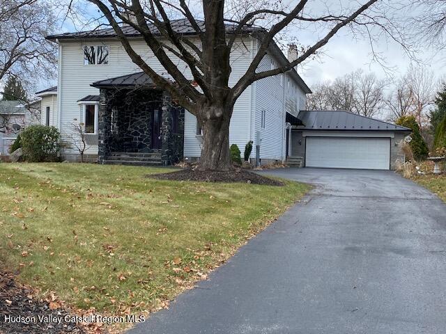 21 Lohmaier Ln, Lake Katrine, NY 12449 - view of front of home with a front lawn, a chimney, asphalt driveway, a garage, and a metal roof