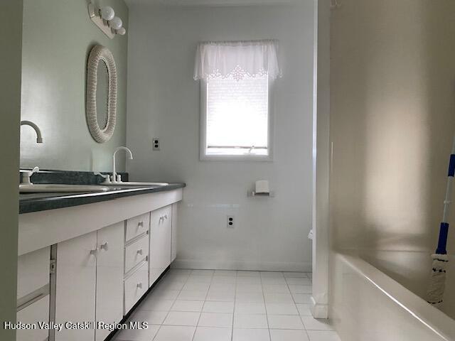 21 Lohmaier Ln, Lake Katrine, NY 12449 - bathroom with double vanity and tile patterned flooring