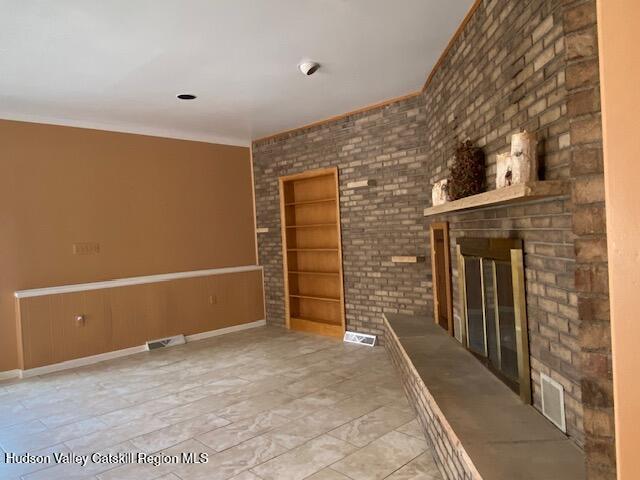 21 Lohmaier Ln, Lake Katrine, NY 12449 - unfurnished living room with built in features and a fireplace
