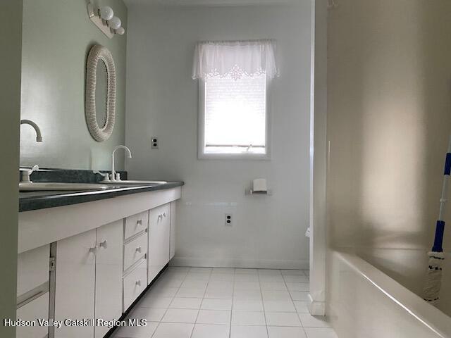 bathroom featuring tile patterned floors and vanity