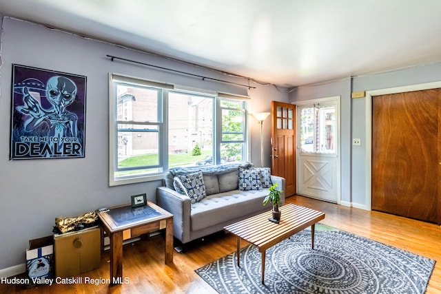 living area with wood finished floors and baseboards