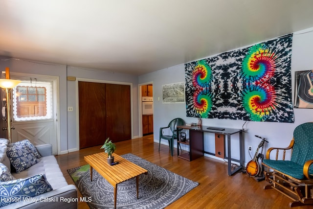 living room featuring baseboards and wood finished floors