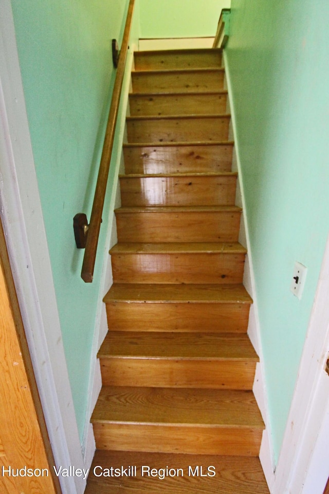 stairs with wood-type flooring