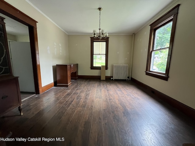 unfurnished dining area with baseboards, ornamental molding, a chandelier, radiator, and dark wood-type flooring