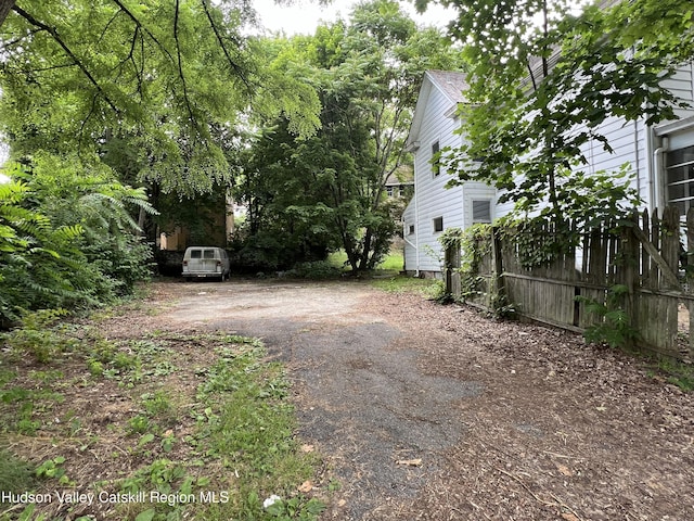 view of yard featuring aphalt driveway