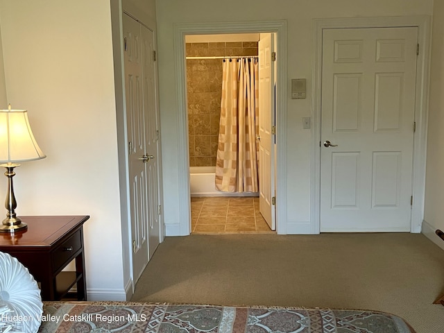 8 Trailside Dr Unit B-9, Hunter, NY 12442 - carpeted bedroom featuring ensuite bath and tile patterned flooring