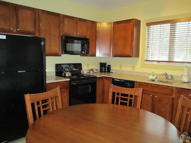62-238E4 Liftside Dr, Hunter, NY 12442 - kitchen featuring black appliances, a sink, brown cabinets, and light countertops