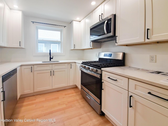 40 Fairview Ave, Hudson, NY 12534 - kitchen featuring appliances with stainless steel finishes, recessed lighting, light wood-type flooring, white cabinets, and light countertops