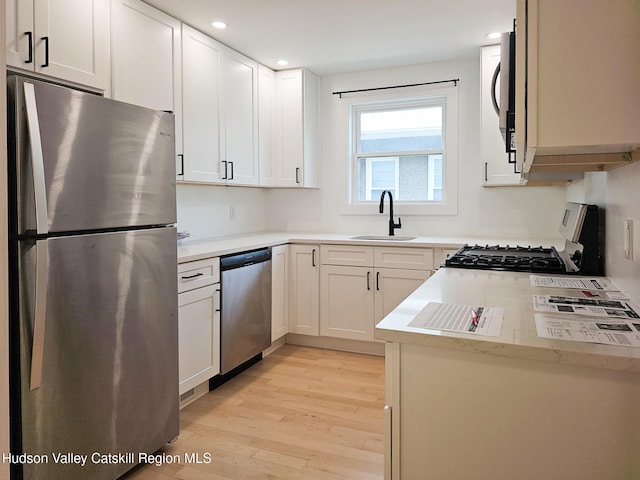 40 Fairview Ave, Hudson, NY 12534 - kitchen with appliances with stainless steel finishes, light wood-type flooring, recessed lighting, white cabinets, and light countertops